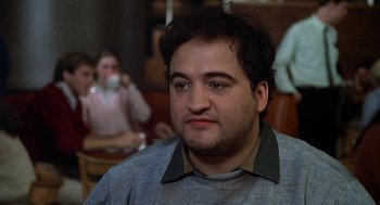 Movie still from “National Lampoon's Animal House” (1978), directed by John Landis – A person sitting in front of another person; Close Up shot, Over the shoulder angle