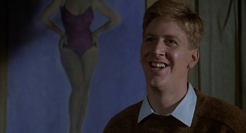 Movie still from “National Lampoon's Animal House” (1978), directed by John Landis – A young man smiling in front of a painting of a woman; Close Up shot, Low angle