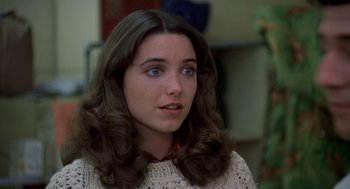 Movie still from “National Lampoon's Animal House” (1978), directed by John Landis – A woman with long brown hair wearing a white sweater; Close Up shot, Over the shoulder angle