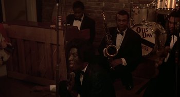 Movie still from “National Lampoon's Animal House” (1978), directed by John Landis – A group of men in tuxedos playing musical instruments; Medium shot, High angle