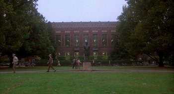 Movie still from “National Lampoon's Animal House” (1978), directed by John Landis – A group of people walking on the grass near a building; Extreme Wide shot, Low angle