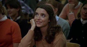 Movie still from “National Lampoon's Animal House” (1978), directed by John Landis – A woman sitting in front of a group of people; Close Up shot, Low angle