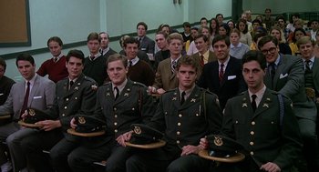 Movie still from “National Lampoon's Animal House” (1978), directed by John Landis – A group of people in uniform sitting in front of a crowd; Wide shot, High angle