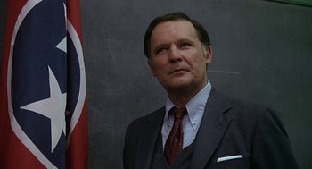 Movie still from “National Lampoon's Animal House” (1978), directed by John Landis – A person wearing a suit and tie; Close Up shot, Low angle