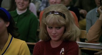 Movie still from “National Lampoon's Animal House” (1978), directed by John Landis – A woman in a red sweater with a brown headband; Close Up shot, Over the shoulder angle