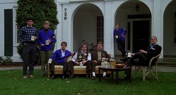 Movie still from “National Lampoon's Animal House” (1978), directed by John Landis – A group of men sitting on a couch in front of a building; Wide shot, Low angle