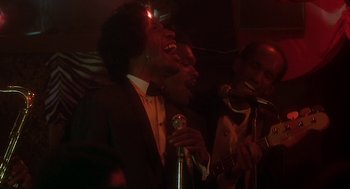 Movie still from “National Lampoon's Animal House” (1978), directed by John Landis – A group of men singing and playing musical instruments; Medium shot, Low angle