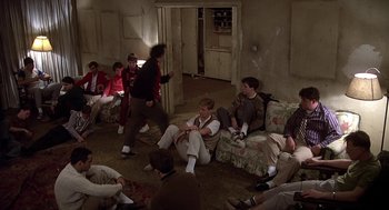 Movie still from “National Lampoon's Animal House” (1978), directed by John Landis – A group of people sitting in a living room together; Wide shot, High angle