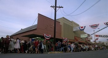 Movie still from “National Lampoon's Animal House” (1978), directed by John Landis – A group of people walking down a street; Extreme Wide shot, High angle