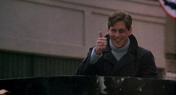 Movie still from “National Lampoon's Animal House” (1978), directed by John Landis – A man giving a thumbs up while sitting at a piano; Medium shot, Low angle