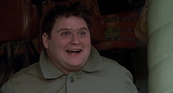 Movie still from “National Lampoon's Animal House” (1978), directed by John Landis – A person with a jacket on smiling; Close Up shot, Low angle