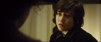 Movie still from “Anna Karenina” (2012), directed by Joe Wright – A person wearing a jacket; Close Up shot, Over the shoulder angle