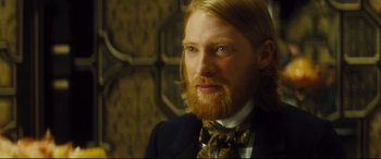 Movie still from “Anna Karenina” (2012), directed by Joe Wright – A person with long hair and a beard; Close Up shot, Over the shoulder angle