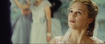 Movie still from “Anna Karenina” (2012), directed by Joe Wright – A woman in a white dress is looking at the camera; Close Up shot, Over the shoulder angle