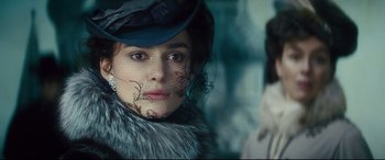 Movie still from “Anna Karenina” (2012), directed by Joe Wright – A person wearing a hat; Close Up shot, Over the shoulder angle