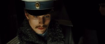 Movie still from “Anna Karenina” (2012), directed by Joe Wright – A person wearing a hat; Close Up shot, Low angle