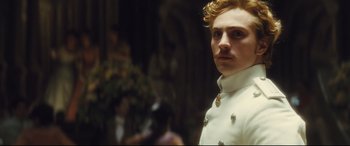 Movie still from “Anna Karenina” (2012), directed by Joe Wright – A person wearing a suit and tie; Close Up shot, Low angle