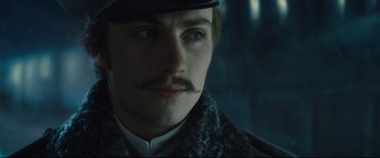 Movie still from “Anna Karenina” (2012), directed by Joe Wright – A person wearing a hat with a mustache; Close Up shot, Low angle