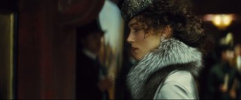 Movie still from “Anna Karenina” (2012), directed by Joe Wright – A person wearing a hat and a fur collar; Close Up shot, Over the shoulder angle