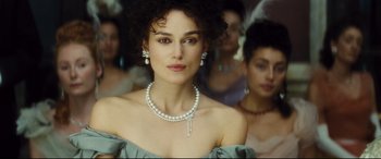 Movie still from “Anna Karenina” (2012), directed by Joe Wright – A person wearing a necklace and earrings; Close Up shot, Over the shoulder angle