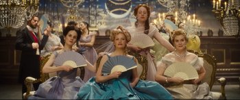 Movie still from “Anna Karenina” (2012), directed by Joe Wright – A group of women holding fans sitting in a room; Medium shot, Low angle