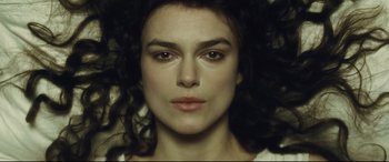 Movie still from “Anna Karenina” (2012), directed by Joe Wright – A woman's face in a dark room; Close Up shot, Overhead angle