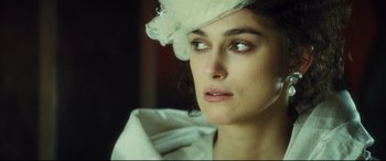 Movie still from “Anna Karenina” (2012), directed by Joe Wright – A person wearing a hat; Close Up shot, Over the shoulder angle