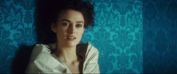 Movie still from “Anna Karenina” (2012), directed by Joe Wright – A person sitting in a room; Close Up shot, Overhead angle