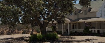 Movie still from “Annabelle: Creation” (2017), directed by David F. Sandberg – A large tree in front of a house; Extreme Wide shot, Low angle