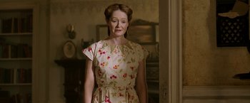 Movie still from “Annabelle: Creation” (2017), directed by David F. Sandberg – An older woman wearing a dress with cherries on it; Medium shot, Over the shoulder angle