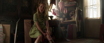 Movie still from “Annabelle: Creation” (2017), directed by David F. Sandberg – A young girl sitting on a chair in a room; Medium shot, Over the shoulder angle