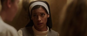 Movie still from “Annabelle: Creation” (2017), directed by David F. Sandberg – A woman wearing a nun's head scarf looking at the camera; Close Up shot, Low angle