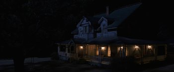 Movie still from “Annabelle: Creation” (2017), directed by David F. Sandberg – A house that has been lit up at night; Extreme Wide shot, High angle