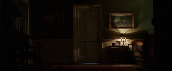 Movie still from “Annabelle: Creation” (2017), directed by David F. Sandberg – A room with a door and a lamp on the wall; Extreme Wide shot, Low angle