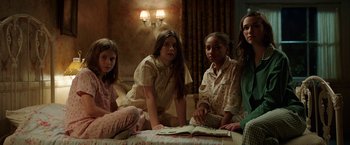 Movie still from “Annabelle: Creation” (2017), directed by David F. Sandberg – A group of young girls sitting on a couch; Medium shot, High angle