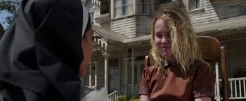Movie still from “Annabelle: Creation” (2017), directed by David F. Sandberg – Two young girls are talking outside of a house; Close Up shot, Over the shoulder angle