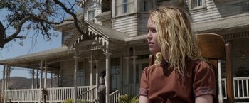 Movie still from “Annabelle: Creation” (2017), directed by David F. Sandberg – A young woman standing outside of a house; Medium shot, Low angle