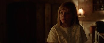 Movie still from “Annabelle: Creation” (2017), directed by David F. Sandberg – A young girl in a white dress is looking at the camera; Close Up shot, Over the shoulder angle
