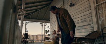 Movie still from “Annabelle: Creation” (2017), directed by David F. Sandberg – An older man and a young woman on a porch; Medium shot, Low angle