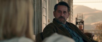 Movie still from “Annabelle: Creation” (2017), directed by David F. Sandberg – A person sitting on a chair near a window; Close Up shot, Over the shoulder angle