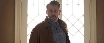 Movie still from “Annabelle: Creation” (2017), directed by David F. Sandberg – A person wearing a jacket; Medium shot, Low angle