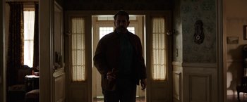 Movie still from “Annabelle: Creation” (2017), directed by David F. Sandberg – A man standing in front of an open door in a house; Medium shot, Low angle