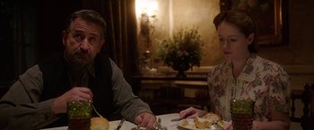 Movie still from “Annabelle: Creation” (2017), directed by David F. Sandberg – A man and a woman sitting at a dinner table; Medium shot, Over the shoulder angle