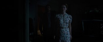 Movie still from “Annabelle: Creation” (2017), directed by David F. Sandberg – A man and a woman standing in a dark room; Medium shot, Low angle