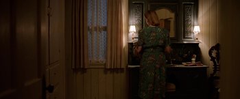 Movie still from “Annabelle: Creation” (2017), directed by David F. Sandberg – A woman standing in front of a window in a room; Medium shot, Low angle