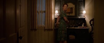 Movie still from “Annabelle: Creation” (2017), directed by David F. Sandberg – A woman standing in front of a bathroom sink; Medium shot, Over the shoulder angle