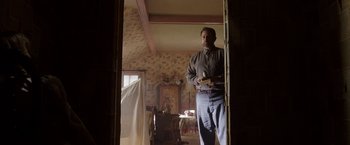 Movie still from “Annabelle: Creation” (2017), directed by David F. Sandberg – A man standing in the doorway of a room; Wide shot, Low angle