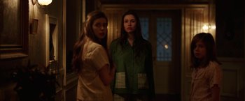 Movie still from “Annabelle: Creation” (2017), directed by David F. Sandberg – Two young women standing in front of an open door at night; Medium shot, Over the shoulder angle