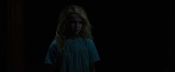 Movie still from “Annabelle: Creation” (2017), directed by David F. Sandberg – A little girl standing in the dark with her hair blowing in the wind; Medium shot, Low angle