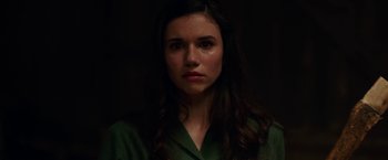 Movie still from “Annabelle: Creation” (2017), directed by David F. Sandberg – A young woman in a green shirt looking at the camera; Close Up shot, High angle